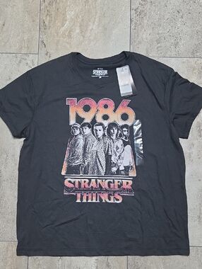 Netflix Stranger Things 1986 Black Tee with Orange-Pink Graphics